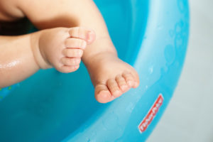 fisher price product photography of baby toes in blue bathtub photographed by boston kids advertising photographer nicole loeb