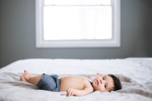 3 month baby boy on bed photographed by boston photographer nicole loeb