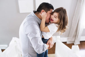 baby girl hugging father in living room photographed by boston photographer nicole loeb