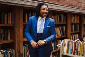 9 Tailors portrait of female in suit at brattle book store photographed by boston photographer nicole loeb