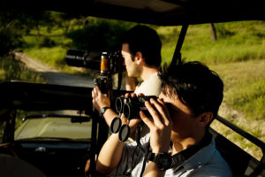 two men photographing in safari photographed by boston travel photographer nicole loeb