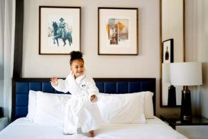 Black mother and toddler daughter in Whitney Hotel room spa night photographed by Boston photographer Nicole Chan