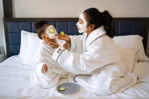 Black mother and toddler daughter in Whitney Hotel room spa night photographed by Boston photographer Nicole Chan
